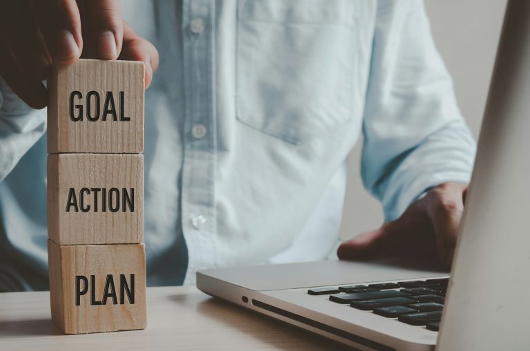 Hands holding cubes Plan and Action for Success Goals with text concept business