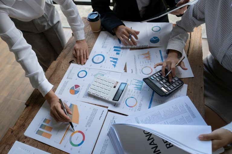 Economic business discussions, Business team analyzing income charts and graphs to plan marketing